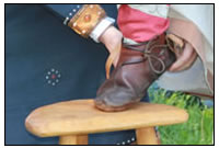 Der F&uumlrst selbst legt dem jungen Ritter den ersten Sporen an.